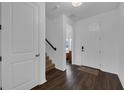 Bright foyer with dark wood flooring, a staircase to the second floor, and a front door at 2210 Derwent Dr, Davenport, FL 33896
