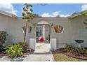 Enclosed front entrance with an arched gateway, adorned with brick accents and decorative wall cutouts at 2312 Poinciana Rd, Winter Park, FL 32792