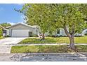 Lovely one-story home with a well-maintained lawn and mature tree at 2312 Poinciana Rd, Winter Park, FL 32792