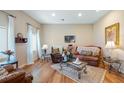Cozy living room featuring hardwood floors, comfortable leather seating, and lots of natural light creating a warm space at 287 Hilltop Dr, Longwood, FL 32750