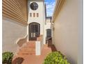 Inviting entrance with tiled steps, arched doorway, and charming exterior architecture at 2926 Claremont Ct # Ge, Orlando, FL 32822