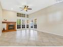 Bright living room featuring tiled floors, a fireplace, and double doors to the patio at 2926 Claremont Ct # Ge, Orlando, FL 32822