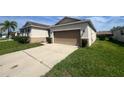 A residential home featuring an attached two-car garage and a well-maintained driveway at 2983 Boating Blvd, Kissimmee, FL 34746