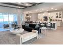 Open-concept living area with modern furniture, neutral tones, and a seamless flow to the kitchen at 3126 Wolf Lake Ave, Apopka, FL 32712