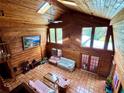 Open living room with wood paneled walls, tiled floors, and an abundance of natural light at 3443 S Mellonville Ave, Sanford, FL 32773
