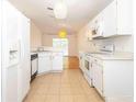 Eat in kitchen featuring white cabinets and a view into the dining area at 4236 Newtonhall Dr, Orlando, FL 32826