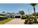 Beautiful single-story house with a brick driveway, lush landscaping, and a well-maintained lawn at 6198 Linneal Beach Dr, Apopka, FL 32703