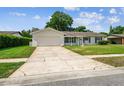 Well-maintained single story home with a spacious driveway and lush front lawn at 620 Marshall St, Altamonte Springs, FL 32701