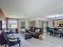 Bright living room with tile floors, comfortable seating, and sliding glass doors at 620 Wood Dr, Kissimmee, FL 34759