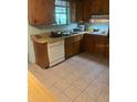 A traditional-style kitchen with wooden cabinets and a double sink at 6251 Bolling Dr, Orlando, FL 32808