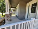 Inviting front porch with stone accents on the columns and a view of the neighborhood at 8230 Corkfield Ave, Orlando, FL 32832