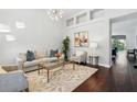 Bright living room with dark floors, modern lighting, and large windows at 8418 Via Bella Notte, Orlando, FL 32836
