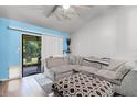 Cozy living room featuring a large sectional sofa and sliding glass doors to the patio at 116 Candlewick Ct, Sanford, FL 32771