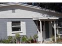 Exterior view of grey and white home with number 1212 above the door at 1212 Leon Ln, Daytona Beach, FL 32117