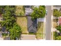 Bird's-eye view of the property showcasing the house, backyard, surrounding trees, and a well-maintained lawn at 1331 19Th St, Orlando, FL 32805