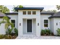 Striking front entrance with a gray front door, decorative lighting, and meticulous landscaping at 1331 19Th St, Orlando, FL 32805