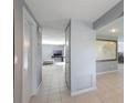 Hallway that leads to a beautifully designed living area, featuring tile floors, a map, and an inviting atmosphere at 1343 Charlotte St, Altamonte Springs, FL 32701