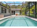 Inviting pool in screened enclosure, perfect for relaxation and outdoor entertainment. Lush landscaping provides privacy at 1343 Charlotte St, Altamonte Springs, FL 32701