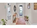 Bright foyer featuring tile floors, a decorative mirror, and a decorative front door at 1425 Lone Wood Blvd, Orlando, FL 32828