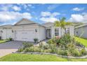 Charming single-story home featuring a two-car garage and a lush landscaped yard at 1425 Lone Wood Blvd, Orlando, FL 32828