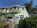 Beautiful townhouse boasting architectural charm and a vibrant garden with lush, colorful hibiscus at 14501 Damai Ln, Orlando, FL 32821