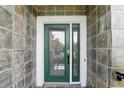 Elegant front door with decorative glass and a secure lock system, enhancing both style and safety at 14501 Damai Ln, Orlando, FL 32821