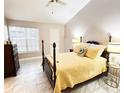 Bright bedroom features neutral walls, vaulted ceiling, tile floor, and a four-poster bed at 1486 Farrindon Cir, Lake Mary, FL 32746