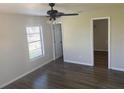 This bedroom has light walls, vinyl flooring, a ceiling fan, and a window for natural light at 1750 Mitten Ter, Deltona, FL 32738