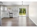 Bright eat-in kitchen with stainless appliances, white cabinets, and sliding glass doors to the backyard at 1750 Mitten Ter, Deltona, FL 32738