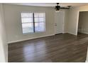 Bright living room features light walls, a ceiling fan, and vinyl plank flooring throughout at 1750 Mitten Ter, Deltona, FL 32738