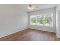 Bright bedroom with hardwood floors and plenty of natural light from three large windows at 181 Longview Ave, Kissimmee, FL 34747
