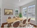 Elegant dining room with wood table, stylish chairs, and large windows at 181 Longview Ave, Kissimmee, FL 34747