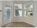 Bright sun room with tiled floor, a glass door, and two large windows at 181 Longview Ave, Kissimmee, FL 34747