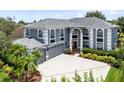 A grand two-story home boasts professional landscaping, a three car garage, and an elegant entrance at 2214 Westbourne Dr, Oviedo, FL 32765