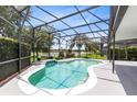 An inviting screened-in pool overlooks a tranquil lake, perfect for outdoor relaxation and entertainment at 2214 Westbourne Dr, Oviedo, FL 32765