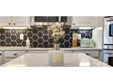 Close up view of a kitchen showcasing modern countertop decor and stylish hexagon backsplash tiles at 245 Via Siena Ln, Lake Mary, FL 32746