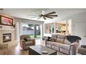 Inviting living room with a cozy fireplace, neutral furnishings, and sliding glass doors to the backyard at 245 Via Siena Ln, Lake Mary, FL 32746