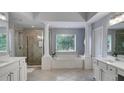 Spacious main bath with a soaking tub, walk-in shower, and dual vanities with white cabinetry at 245 Via Siena Ln, Lake Mary, FL 32746