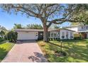 Beautiful single-story home with a brick driveway, well-manicured lawn, and inviting entrance, showcasing its curb appeal at 2520 Chanute Trl, Maitland, FL 32751
