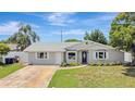 Inviting single-story home with white trim, lovely landscaping, and a sunny front yard at 2835 Bongart Rd, Winter Park, FL 32792