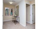 Bright hallway featuring neutral carpeting, modern decor, and access to multiple rooms at 2928 Buccaneer Palm Rd, Kissimmee, FL 34747