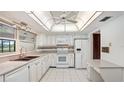 Bright kitchen featuring white cabinetry, modern appliances, and ample counter space for meal preparation at 316 Cambridge Dr, Longwood, FL 32779