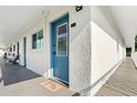 Exterior hallway with blue doors, textured walls, and a sliver of a view at 320 Lakeview St # 220, Orlando, FL 32804