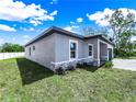 Home exterior featuring well-maintained landscaping, decorative stone accents, and neutral-colored stucco at 331 Erie Ct, Kissimmee, FL 34759