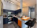 Modern kitchen with stainless steel appliances and open layout to living area at 3391 S Kirkman Rd # 1236, Orlando, FL 32811