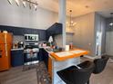 Modern kitchen featuring stainless steel appliances and stylish navy blue cabinets at 3391 S Kirkman Rd # 1236, Orlando, FL 32811