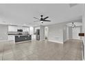 Open floor plan combining living room and kitchen with tile flooring and modern finishes at 3405 Yarian Dr, Haines City, FL 33844