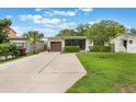 Cozy single-story home with a well-maintained lawn, brown garage door, and lush landscaping at 3460 Fairway Ln, Orlando, FL 32804
