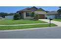 Inviting one-story home featuring a lush green lawn and a well-maintained landscape at 3529 Harlequin Dr, St Cloud, FL 34772