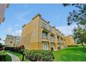 Three-story townhome featuring balconies, well-manicured lawns, and lush greenery at 4816 Tidecrest Ave # 178, Orlando, FL 32819